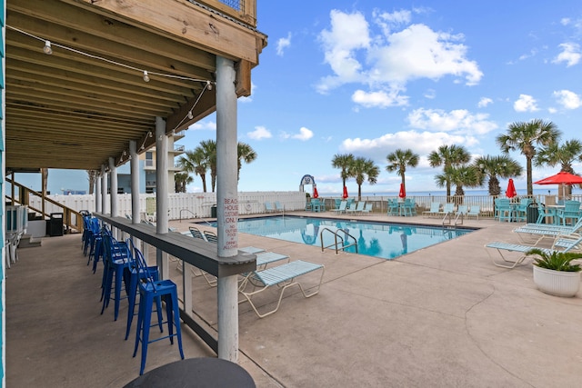 view of swimming pool featuring a patio area