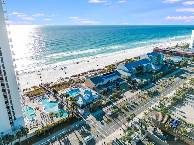 drone / aerial view featuring a water view and a beach view