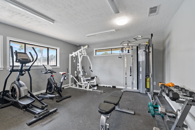 gym featuring a textured ceiling