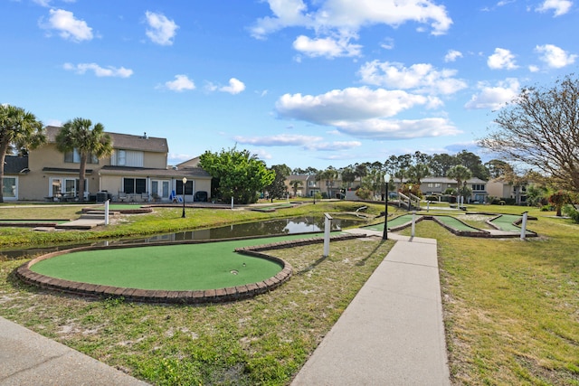 view of home's community featuring a lawn and a water view