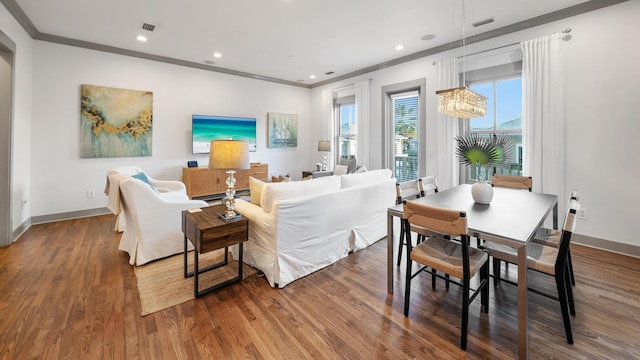 living room featuring hardwood / wood-style flooring and crown molding