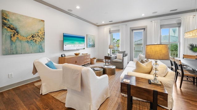 living room with crown molding and hardwood / wood-style floors