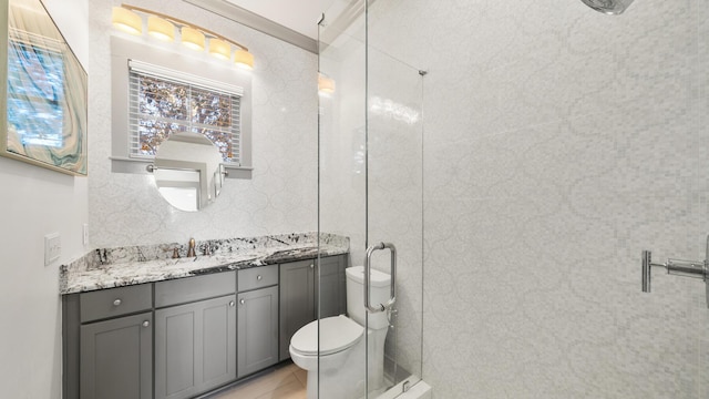 bathroom featuring vanity, toilet, and crown molding