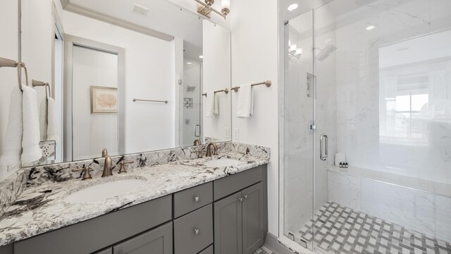 bathroom with vanity and a shower with door