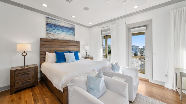 bedroom featuring access to exterior, hardwood / wood-style flooring, and ornamental molding