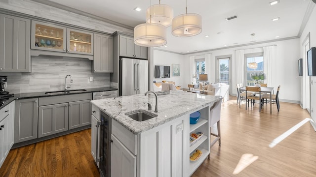 kitchen featuring gray cabinetry, sink, hanging light fixtures, and high end refrigerator