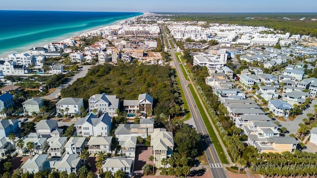 birds eye view of property with a water view and a beach view