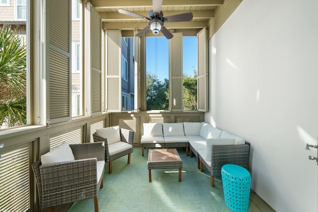 sunroom featuring ceiling fan, beam ceiling, and wooden ceiling