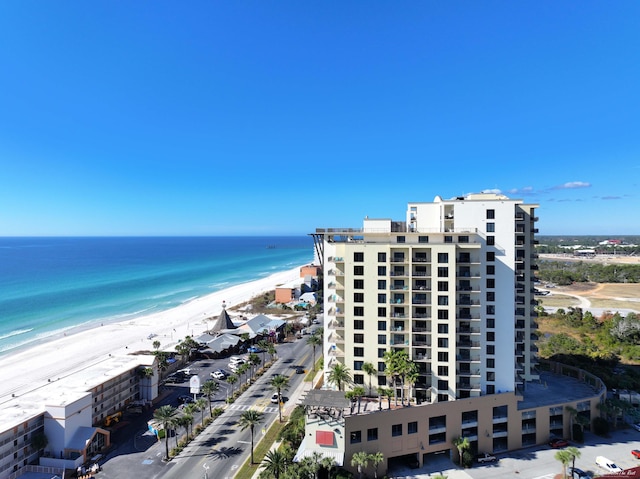 birds eye view of property featuring a beach view and a water view