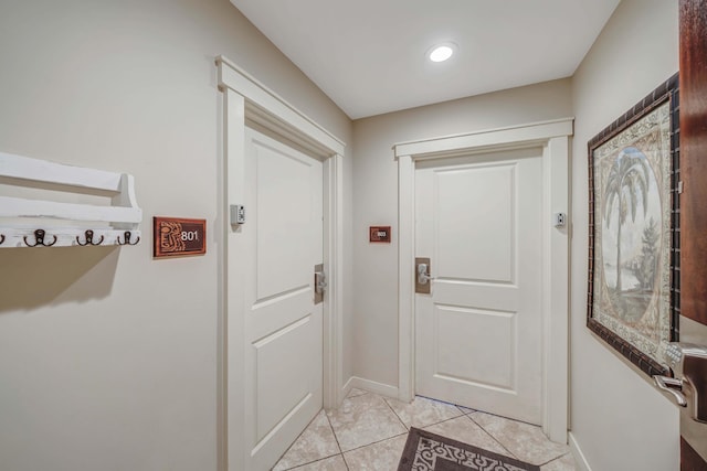 doorway to outside with light tile patterned floors