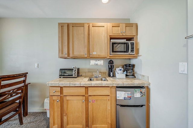 kitchen with tile countertops, refrigerator, sink, and dark carpet