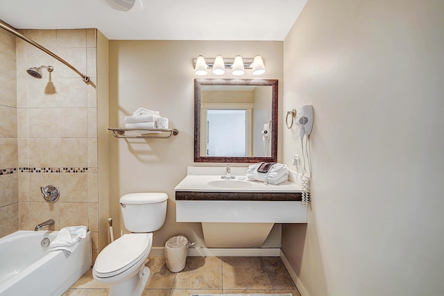 full bathroom with tile patterned floors, toilet, vanity, and tiled shower / bath