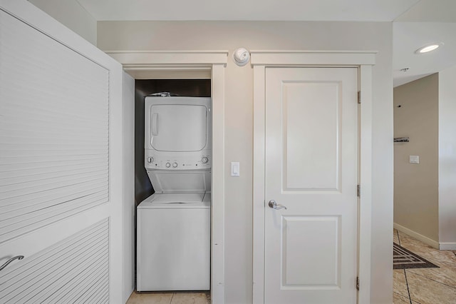 laundry area with stacked washing maching and dryer