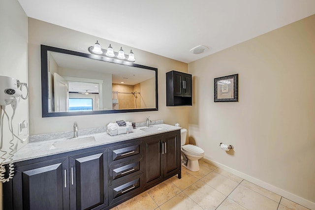 bathroom featuring tile patterned floors, a shower, vanity, and toilet