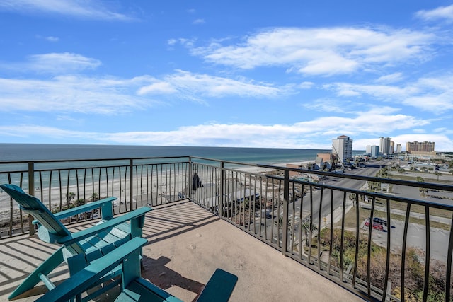 balcony featuring a water view and a view of the beach