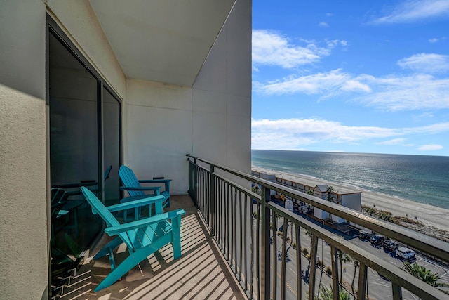 balcony with a view of the beach and a water view