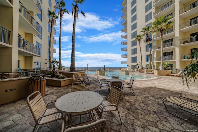 view of patio / terrace featuring a water view and a community pool