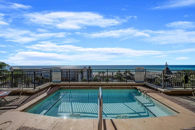 view of swimming pool featuring a water view