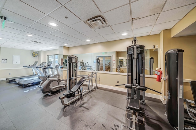 gym with a paneled ceiling