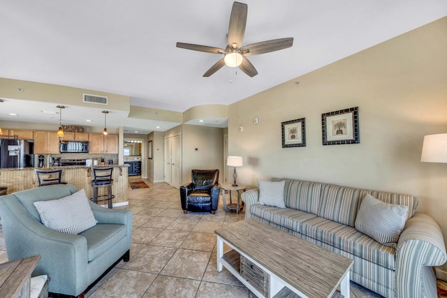 living room with ceiling fan and light tile patterned flooring