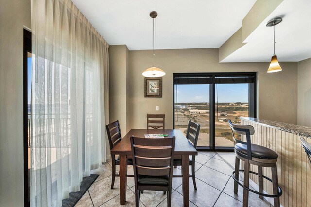 dining area featuring light tile patterned flooring