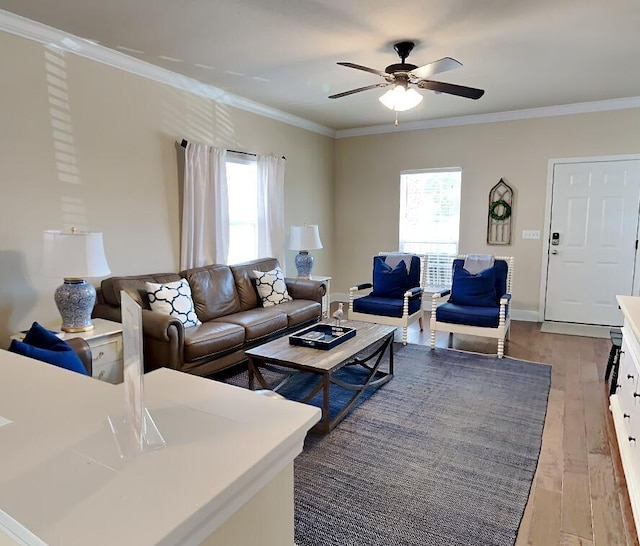 living room featuring crown molding, a healthy amount of sunlight, and hardwood / wood-style flooring