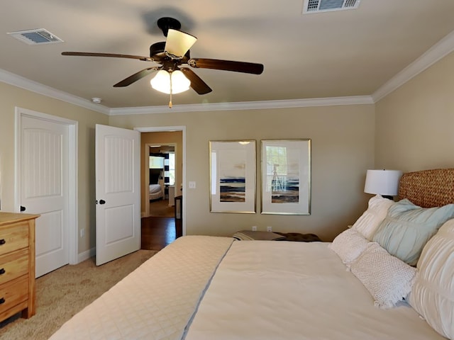 bedroom featuring ceiling fan, carpet floors, and ornamental molding