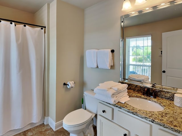 bathroom with tile patterned flooring, vanity, and toilet