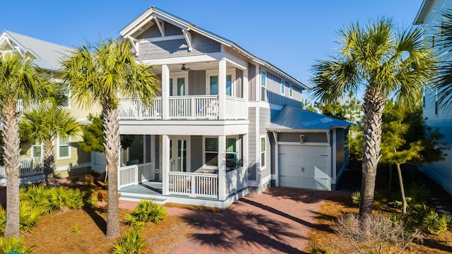 back of house featuring covered porch and a garage