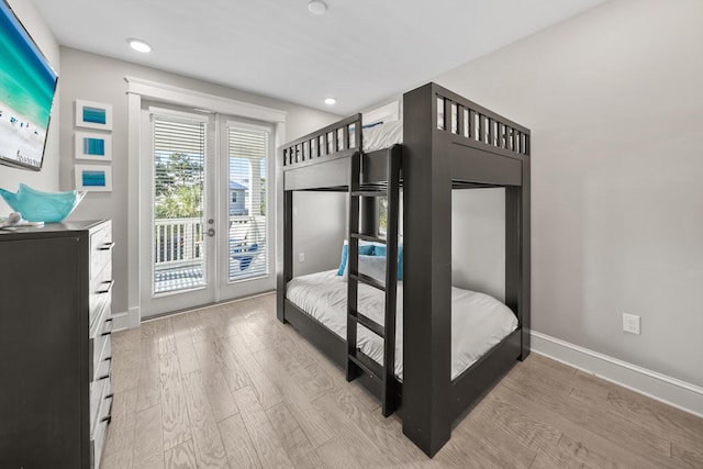 bedroom featuring access to exterior and light wood-type flooring