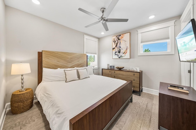 bedroom with ceiling fan and light wood-type flooring