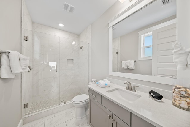 bathroom with vanity, toilet, and walk in shower