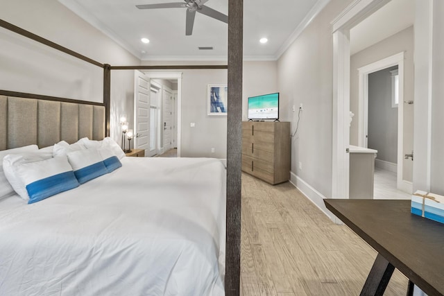 bedroom featuring ceiling fan, light hardwood / wood-style floors, ornamental molding, and ensuite bath