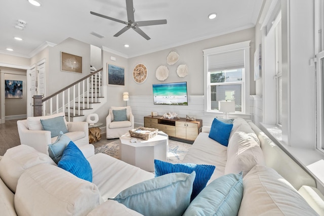 living room with wood-type flooring, ceiling fan, and crown molding