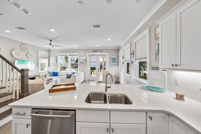 kitchen with dishwasher, white cabinets, crown molding, sink, and ceiling fan