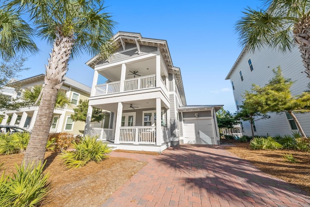 beach home with ceiling fan, covered porch, and a balcony