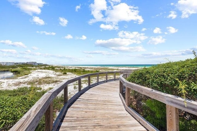 view of property's community with a beach view and a water view