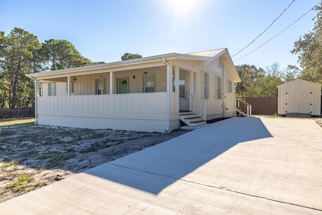 view of front of house featuring a storage unit