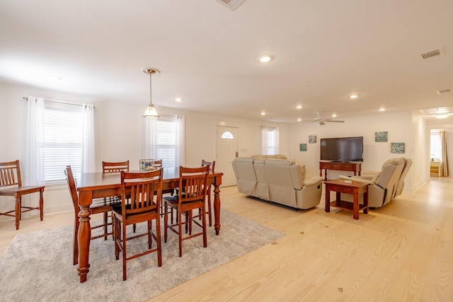 dining room with ceiling fan and light wood-type flooring