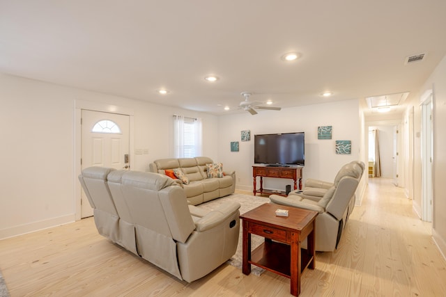 living room with light wood-type flooring and ceiling fan