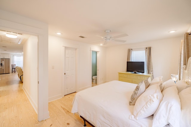 bedroom featuring multiple windows, stainless steel fridge with ice dispenser, light hardwood / wood-style floors, and ceiling fan