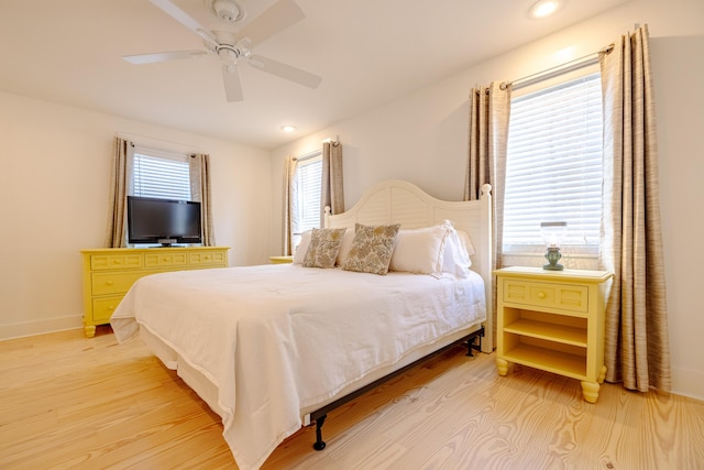 bedroom with light wood-type flooring and ceiling fan