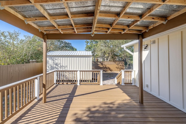 wooden terrace featuring a shed