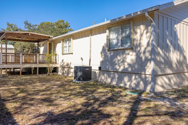 view of home's exterior featuring cooling unit and a wooden deck