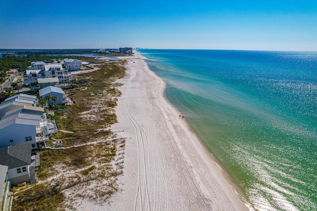 drone / aerial view featuring a water view and a beach view