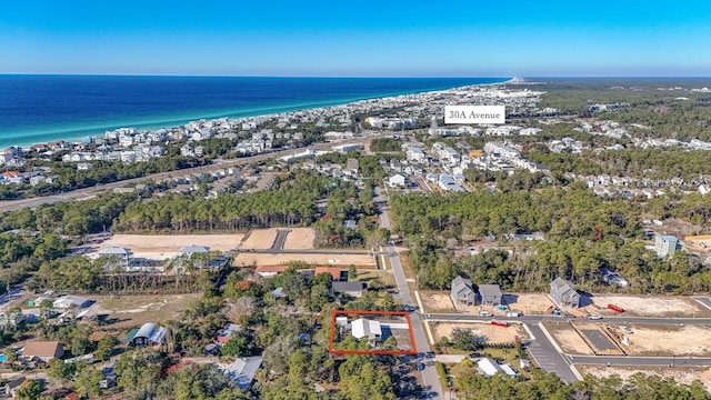 aerial view with a water view and a view of the beach