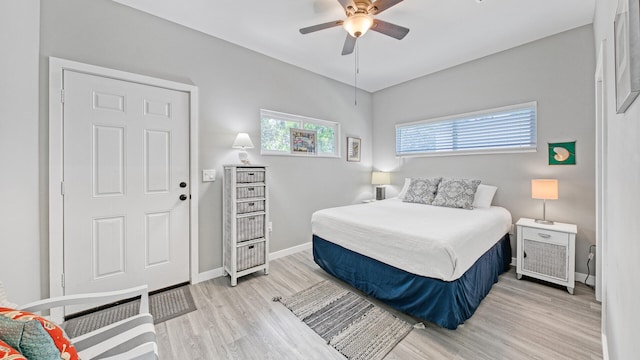 bedroom with light hardwood / wood-style floors and ceiling fan