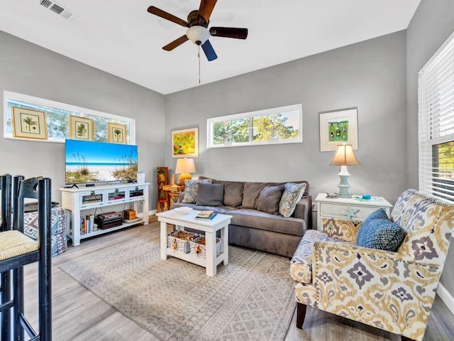 living room featuring hardwood / wood-style flooring and ceiling fan