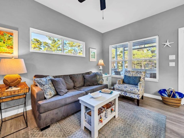 living room featuring hardwood / wood-style floors and ceiling fan