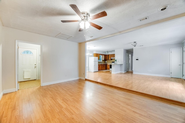 unfurnished living room with ceiling fan, light hardwood / wood-style floors, and a textured ceiling